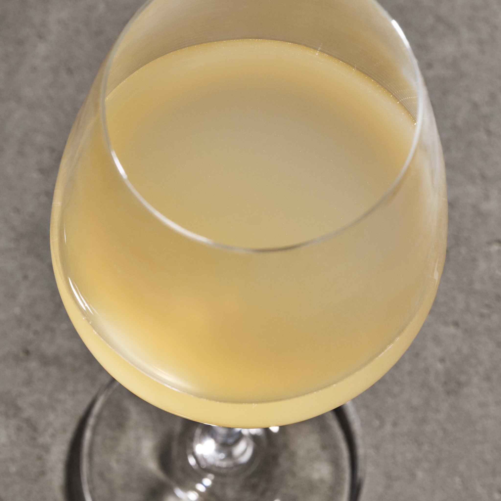 Glass of white wine on a gray surface